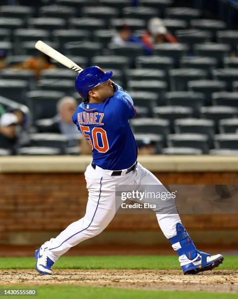 Francisco Alvarez of the New York Mets watches his solo home run in the sixth inning against the Washington Nationals during game two of a double...