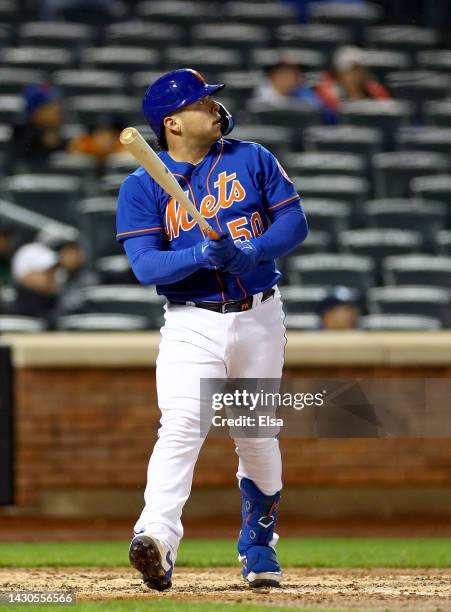 Francisco Alvarez of the New York Mets watches his solo home run in the sixth inning against the Washington Nationals during game two of a double...