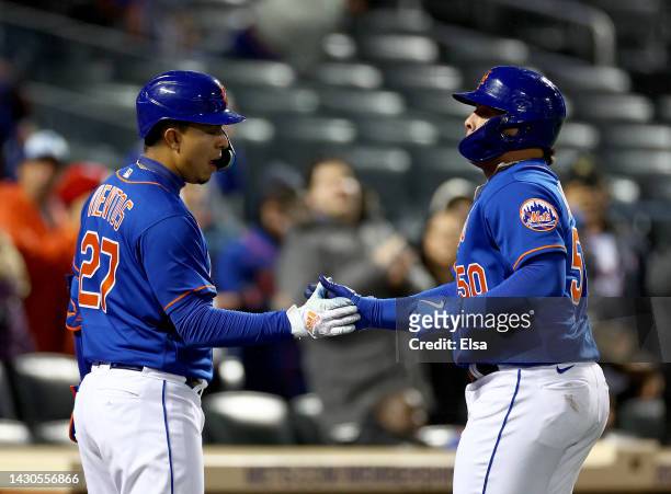 Mark Vientos of the New York Mets congratulates teammate Francisco Alvarez after Alvarez hit his first Major League home run in the sixth inning...