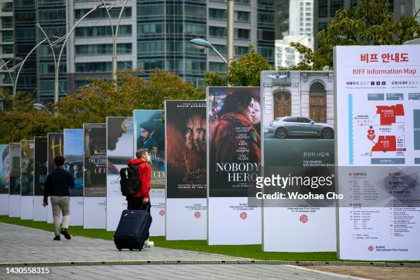 People walk by movie poster-stands at Busan Cinema Center during the 27th Busan International Film Festival on October 5, 2022 in Busan, South Korea.