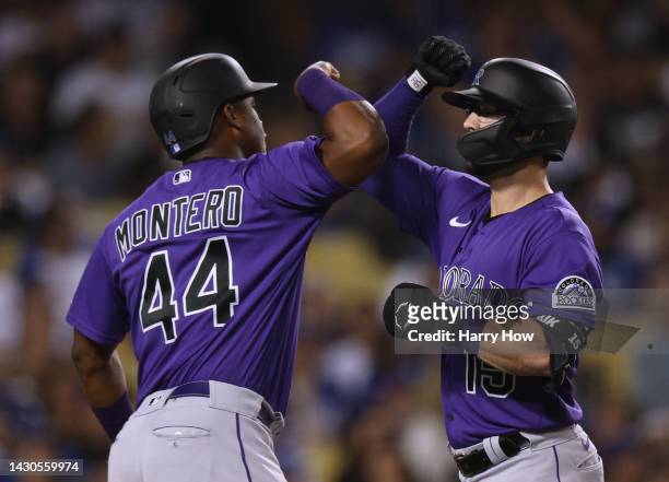 Randal Grichuk of the Colorado Rockies celebrates his two run homerun with Elehuris Montero, to take a 4-2 lead over the Los Angeles Dodgers, during...