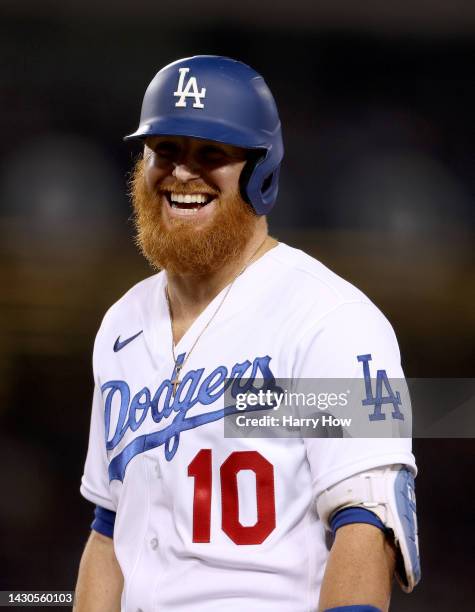 Justin Turner of the Los Angeles Dodgers laughs after his single during the sixth inning against the Colorado Rockies at Dodger Stadium on October...