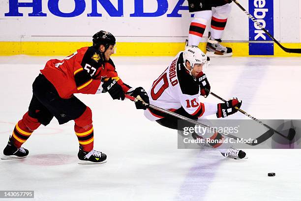 Peter Harrold of the New Jersey Devils skates with the puck as Marcel Goc of the Florida Panthers chases during Game Two of the Eastern Conference...