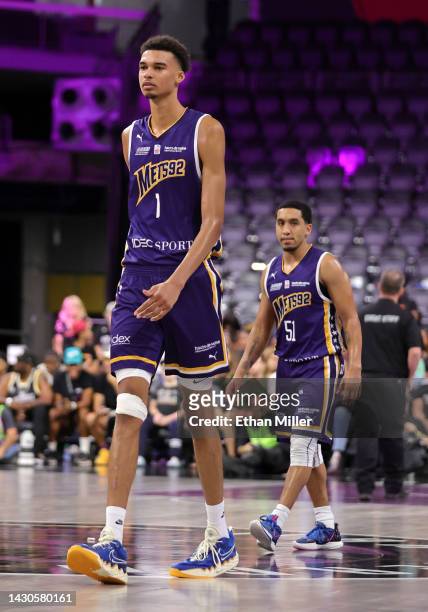 Victor Wembanyama of Boulogne-Levallois Metropolitans 92 walks ahead of teammate Tremont Waters as they return to the court after a timeout in the...