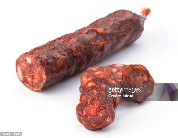 iberian sausage cut isolated on white - chorizo stockfoto's en -beelden