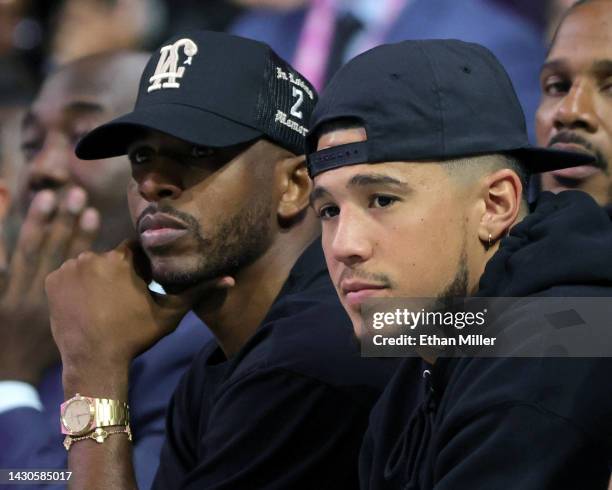 Players Chris Paul and Devin Booker of the Phoenix Suns attend an exhibition game between Boulogne-Levallois Metropolitans 92 and G League Ignite at...