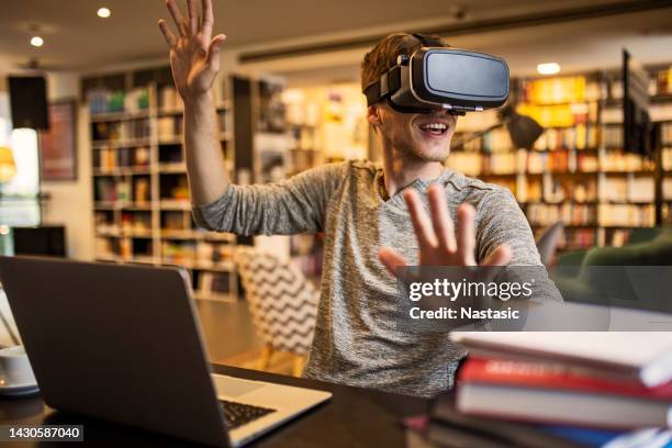using vr headset in library - virtual library stock pictures, royalty-free photos & images
