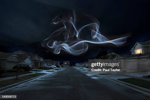 glowing shape over suburbs - spooky smoke stock pictures, royalty-free photos & images