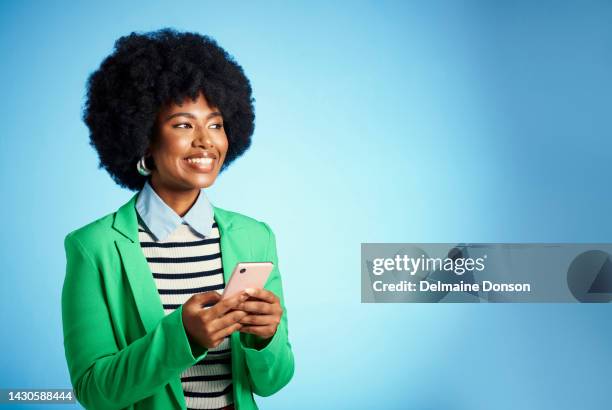 smartphone technology, black woman in business online and internet connection. check social media application, entrepreneur digital success and happy afro girl typing email in studio blue background - checking phone bildbanksfoton och bilder