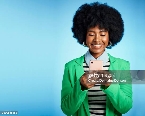 phone, social media and afro black woman in communication on mobile, happy with online service and tech against blue mockup studio background. african worker on web app with technology - checking phone bildbanksfoton och bilder