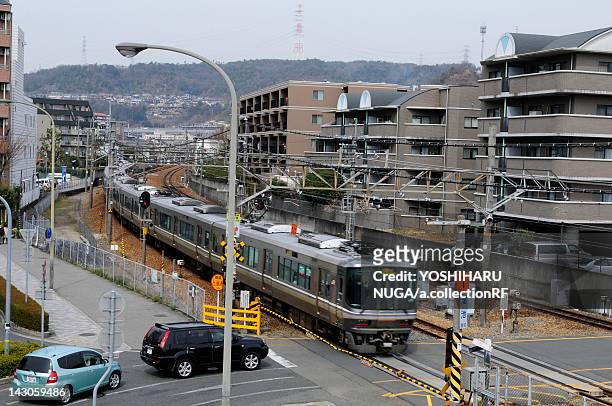 commuter train and level crossing - präfektur hyogo stock-fotos und bilder