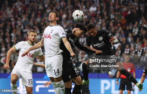 Clement Lenglet of Tottenham Hotspur jumps for a header with Daichi Kamada and Tuta of Eintracht Frankfurt during the UEFA Champions League group D...