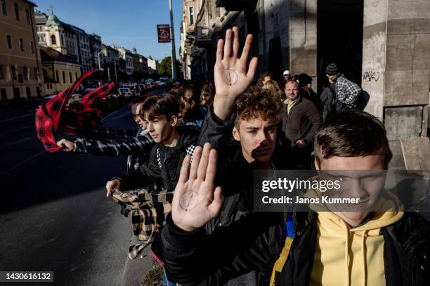 Students waving with checkered shirts - symbol of the teachers' movement - the during a solidarity act and demonstration on October 5, 2022 in...