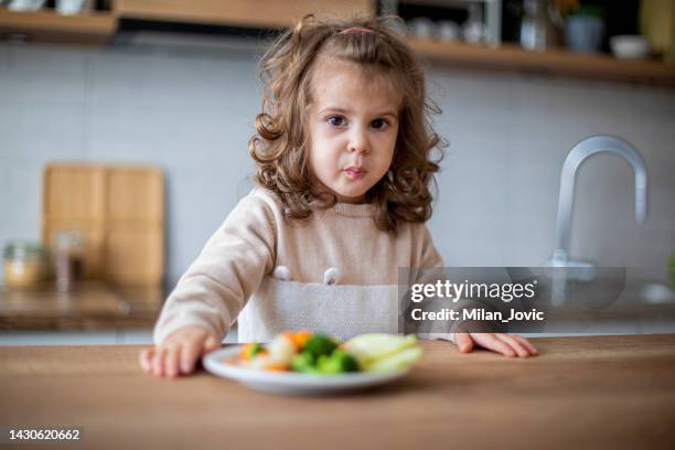 cute baby girl drinking green smoothie and eating vegetables - fresh baby spinach stock pictures, royalty-free photos & images