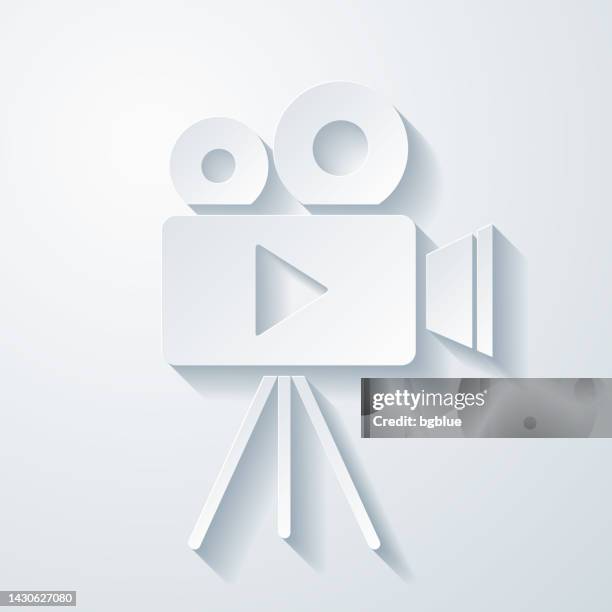 video camera with tripod. icon with paper cut effect on blank background - vintage television white background stock illustrations