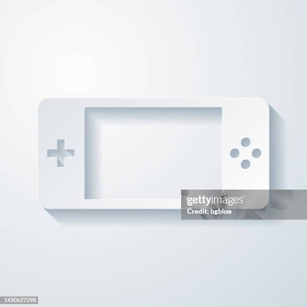 handheld game console. icon with paper cut effect on blank background - console controller isolated stock illustrations