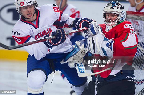 Slovenian Ziga Jeglic vies with Hungarian goalkeeper Bence Balizs during the 2012 IIHF Ice Hockey World Championship Div I Group A match between...
