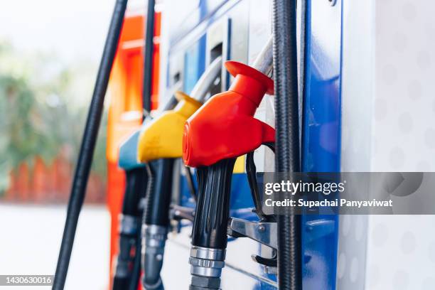 fuel nozzles, close-up of fuel pumps at gas station - pumping gas stock-fotos und bilder