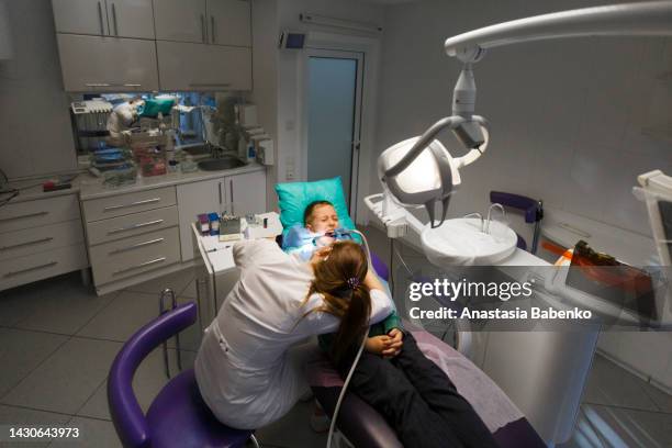 boy in a dentist cabinet - dentista bambini foto e immagini stock