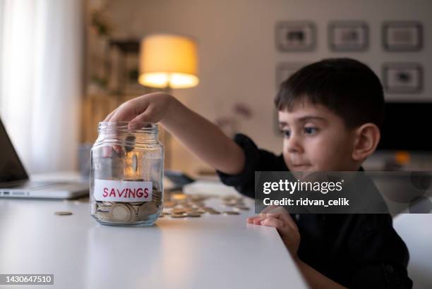 saving money - boys money stock pictures, royalty-free photos & images