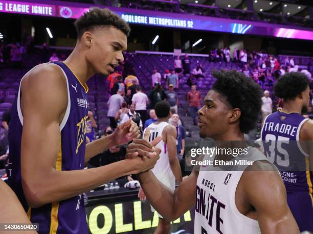 Victor Wembanyama of Boulogne-Levallois Metropolitans 92 and Scoot Henderson of G League Ignite shake hands after their exhibition game at The Dollar...