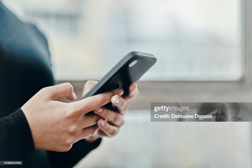 Woman, phone and hands macro while typing in office, home or room on web. Girl, smartphone and social media in office send email, post blog or communication, on internet or app on cellphone in zoom