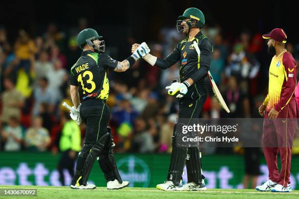 Matthew Wade and Mitchell Starc of Australia celebrate winning game one of the T20 International series between Australia and the West Indies at...