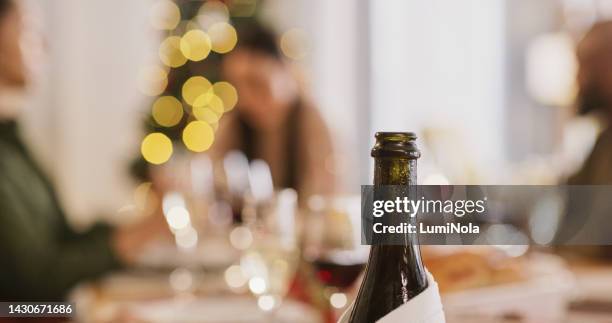 wine, bottle and closeup at christmas party, event or celebration. luxury, champagne and green glass for alcohol or sparkling grape juice at wedding, restaurant or dinner in macro for mockup - christmas background no people stock pictures, royalty-free photos & images