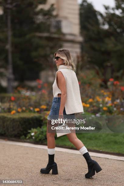 Xenia Adonts seen wearing a white hermès mini kelly bag and miu miu shorts, outside Zimmermann during Paris Fashion Week on October 03, 2022 in...