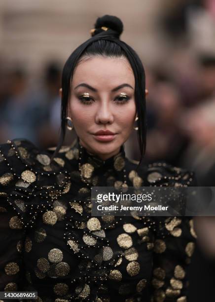 Jessica Wang seen wearing a black and gold patterned dress, outside Zimmermann during Paris Fashion Week on October 03, 2022 in Paris, France.