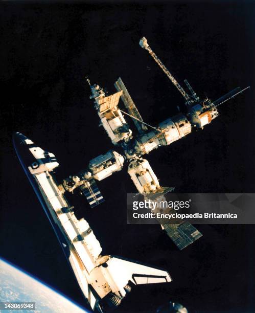 Space Shuttle Atlantis Docks With Mir, U.S, Space Shuttle Atlantis Docked With The Russian Space Station Mir, In A Photograph Taken By Cosmonaut...