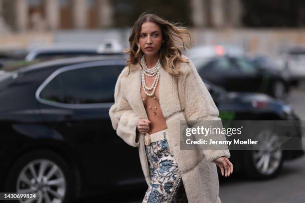 Carla Ginola seen wearing a fur coat and patterned pants, outside Zimmermann during Paris Fashion Week on October 03, 2022 in Paris, France.