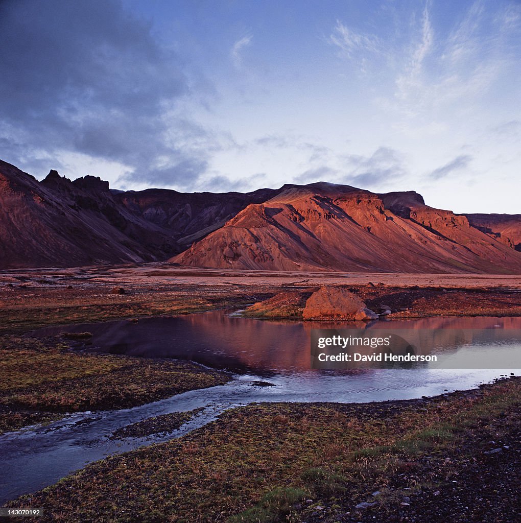 Rock formations reflected in still river