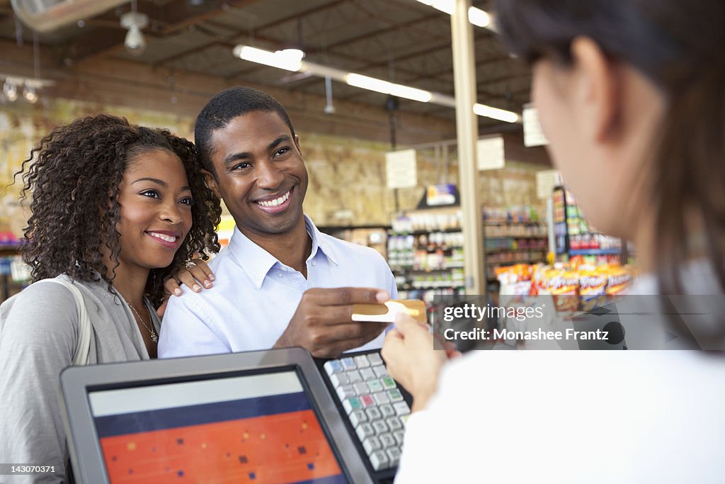 Couple buying groceries in supermarket