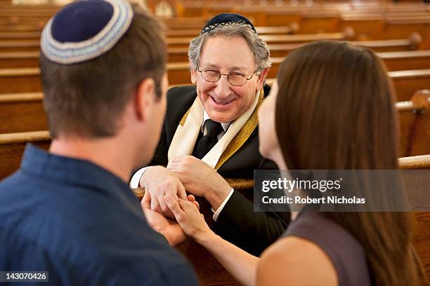 couple talking with rabbi in synagogue - the last rabi fotografías e imágenes de stock