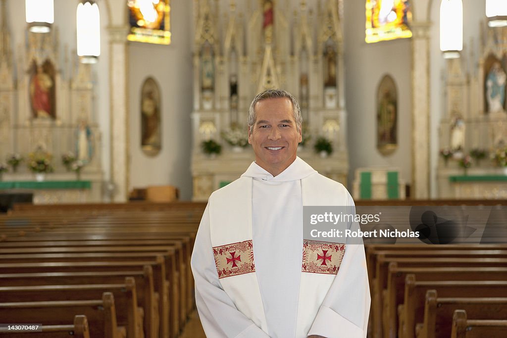 Priest standing in ornate church