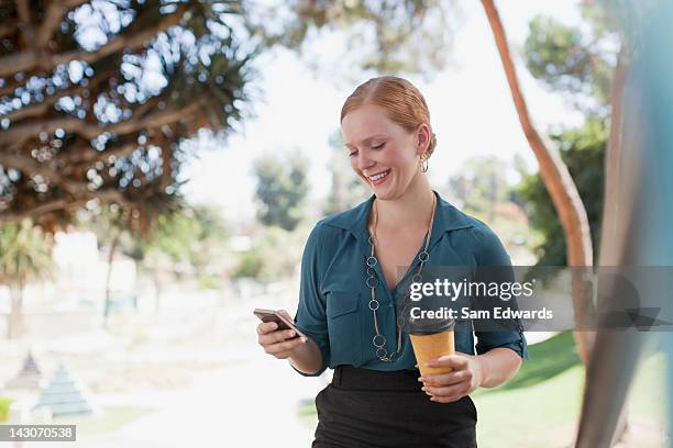 businesswoman using cell phone outdoors - samuser stock pictures, royalty-free photos & images