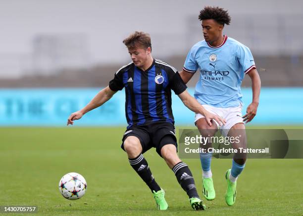 Emil Rosberg Moller of F.C. Copenhagen is challenged by Kane Taylor of Manchester City during the UEFA Youth League match between Manchester City and...