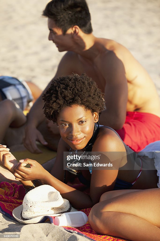 Friends relaxing on beach blanket