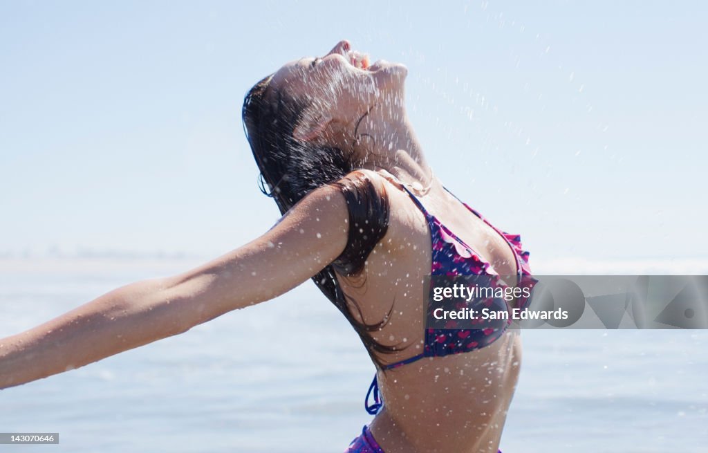 Woman playing in waves on beach