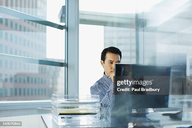 businessman working at desk in office - windows pc stock pictures, royalty-free photos & images