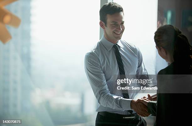 business people shaking hands in office - corporate business handshake stock pictures, royalty-free photos & images