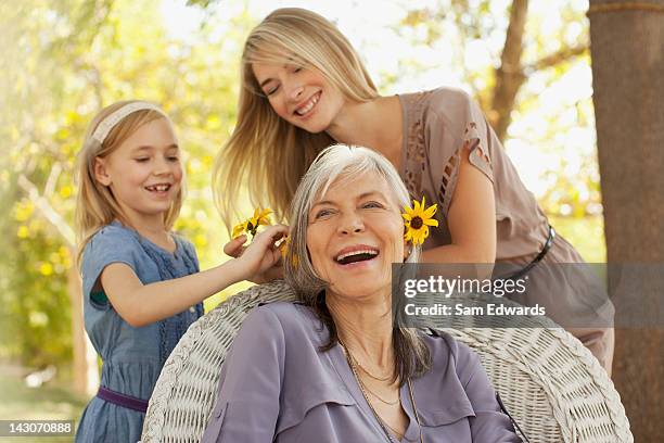 three generations of women playing outdoors - beautiful asian girls stockfoto's en -beelden