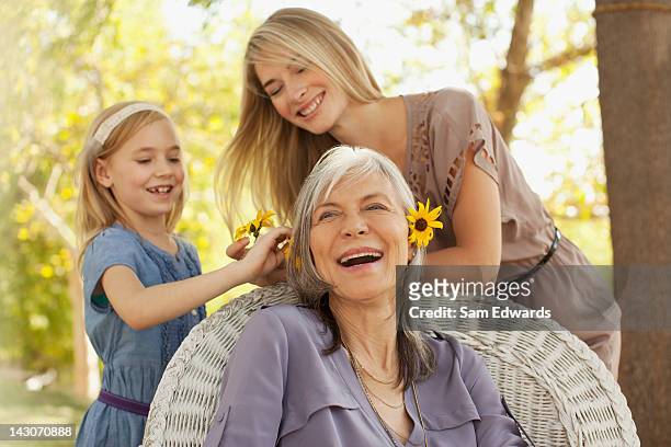 three generations of women playing outdoors - granddaughter stock pictures, royalty-free photos & images