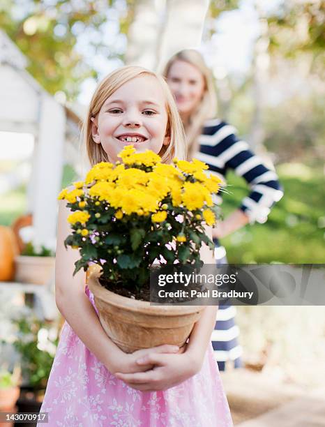 girl holding potted plant outdoors - carrying pot plant stock pictures, royalty-free photos & images