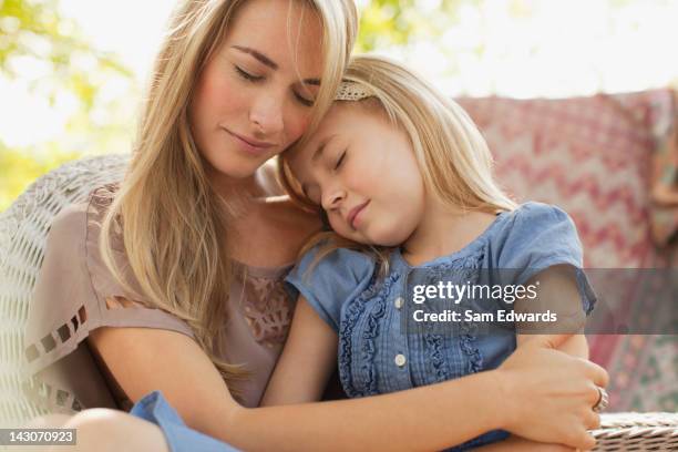 mother and daughter relaxing together - hug sleep woman stock pictures, royalty-free photos & images