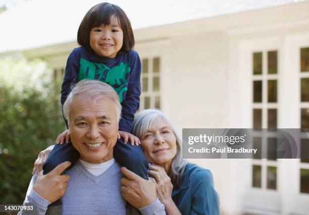 older couple and grandson standing outdoors - day california stock pictures, royalty-free photos & images