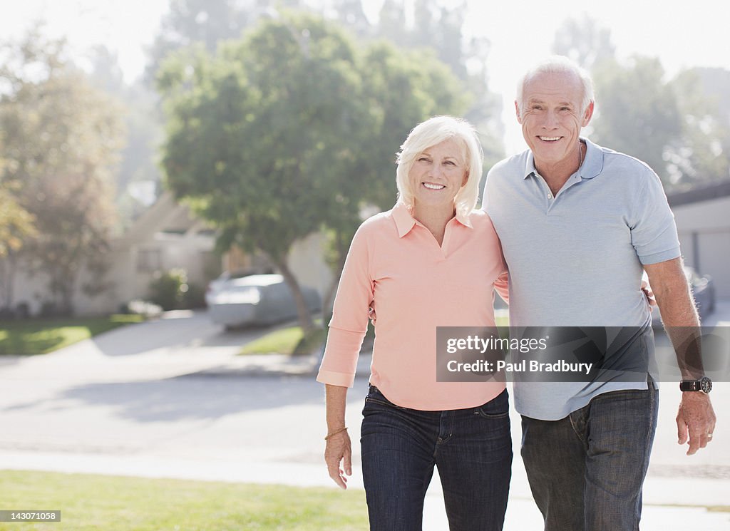 Smiling older couple walking together