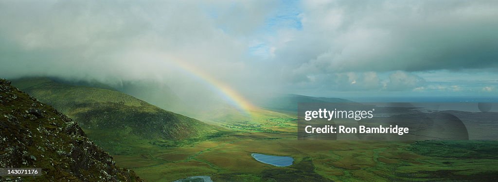 Rainbow stretching over rural landscape