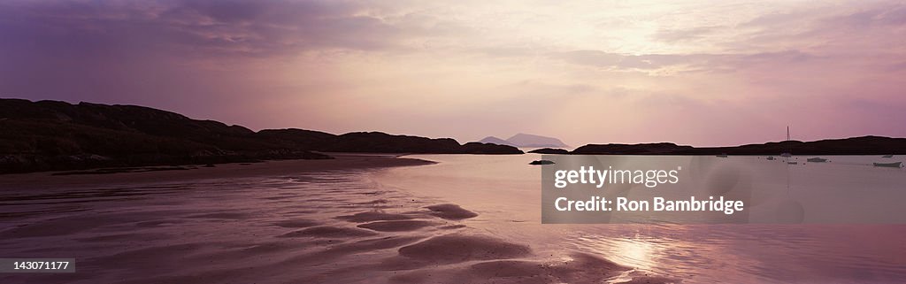 Waves washing up on sandy beach
